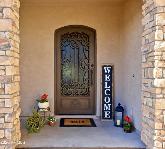 a view of a room that has a bed and a table in it