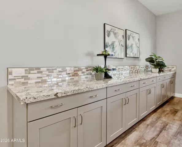 a living room with a couch a window and a flat screen tv