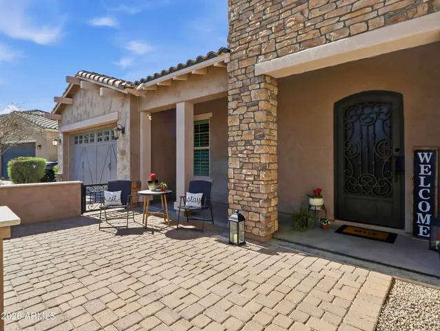a view of a house with swimming pool and sitting area