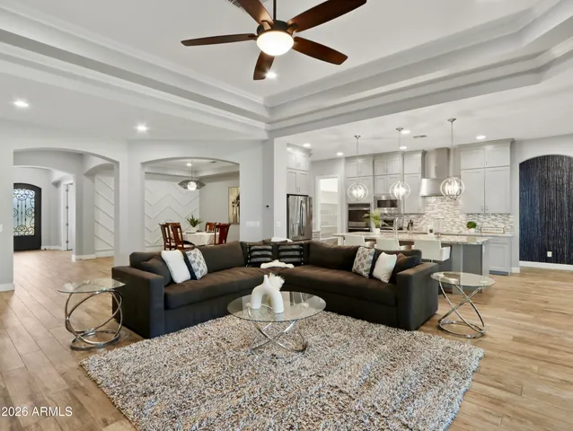 a dining room with furniture a large window and kitchen view