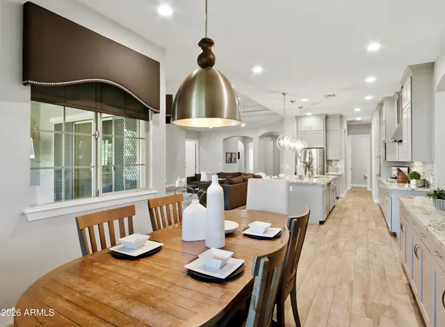 a spacious bathroom with a double vanity sink mirror and bathtub