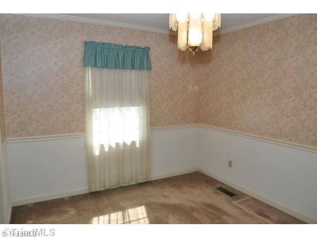 7012 Harperglen Road Clemmons, NC 27012 - Photo 4 of 16 Dining Room. The dining room has great "bones" with its moldings and wainscoting.