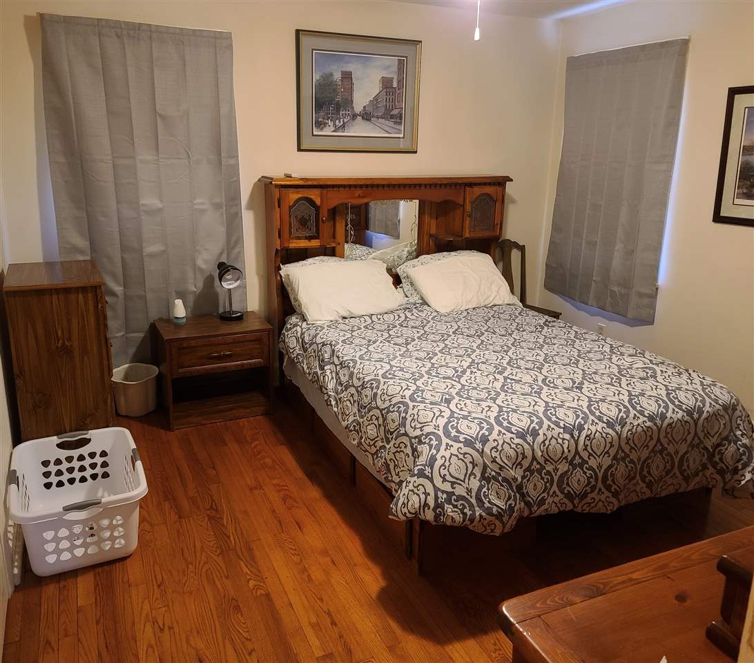 3732 Healey Road Memphis, TN 38111 - Photo 5 of 11 a bed sitting in a bedroom next to a wooden floor