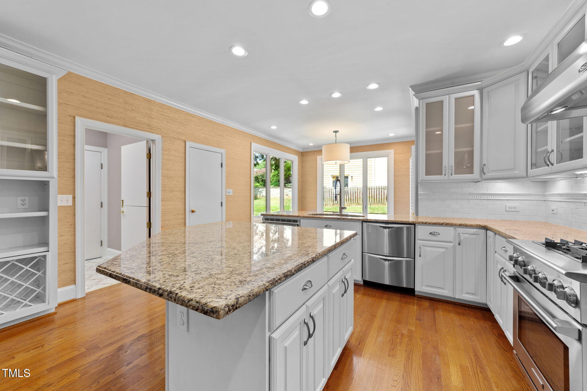 2613 Hawtree Drive Raleigh, NC 27613 - Photo 12 of 47 a kitchen with granite countertop kitchen island a sink appliances and cabinets