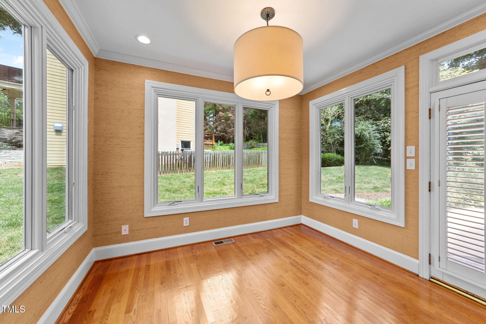 2613 Hawtree Drive Raleigh, NC 27613 - Photo 15 of 47 a view of an empty room with a window and wooden floor