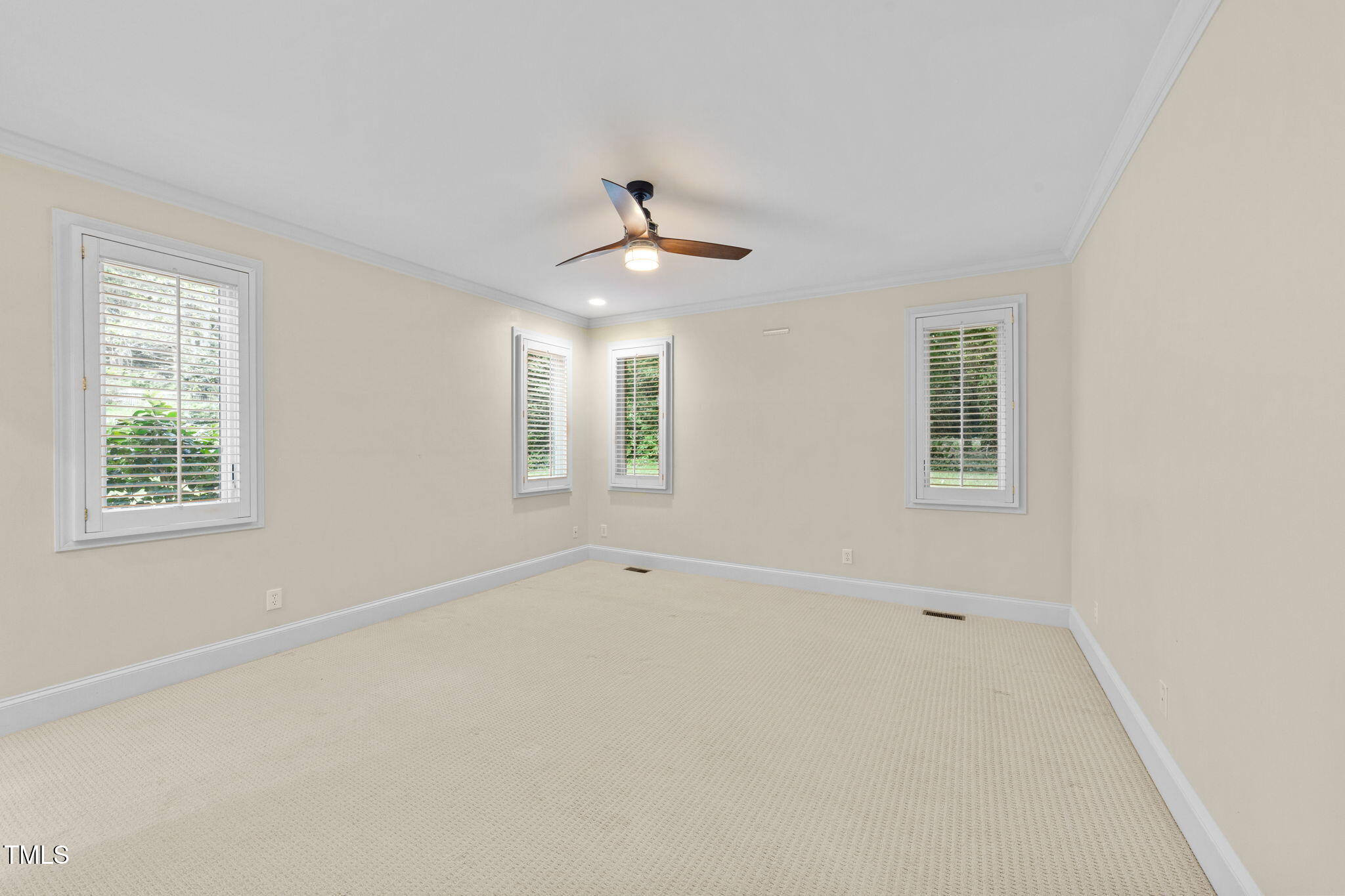 2613 Hawtree Drive Raleigh, NC 27613 - Photo 18 of 47 an empty room with a window and a ceiling fan