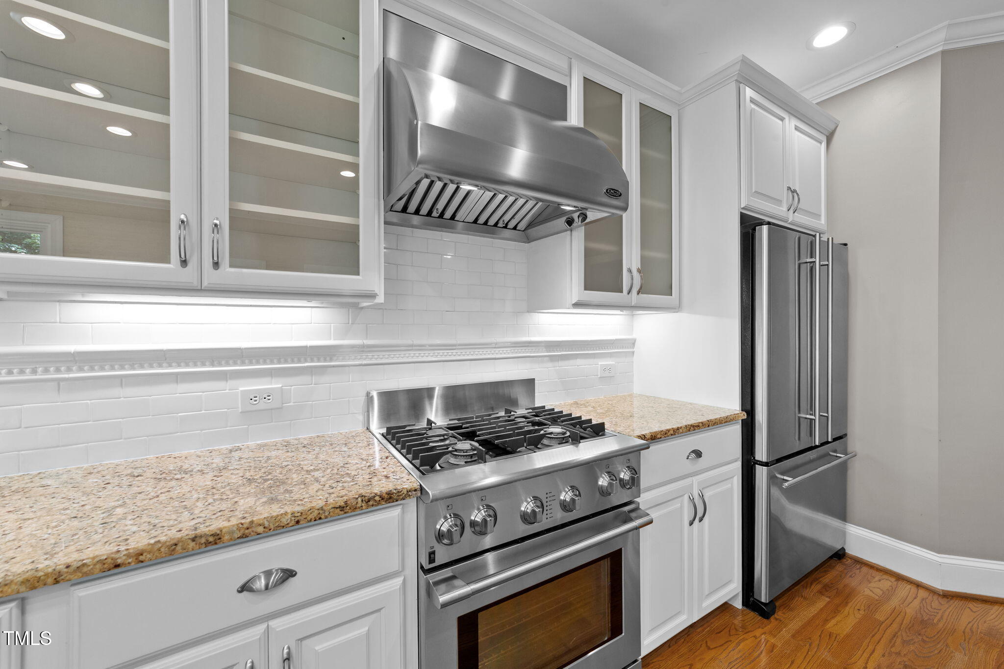 2613 Hawtree Drive Raleigh, NC 27613 - Photo 3 of 47 a kitchen with granite countertop stainless steel appliances a stove and a refrigerator