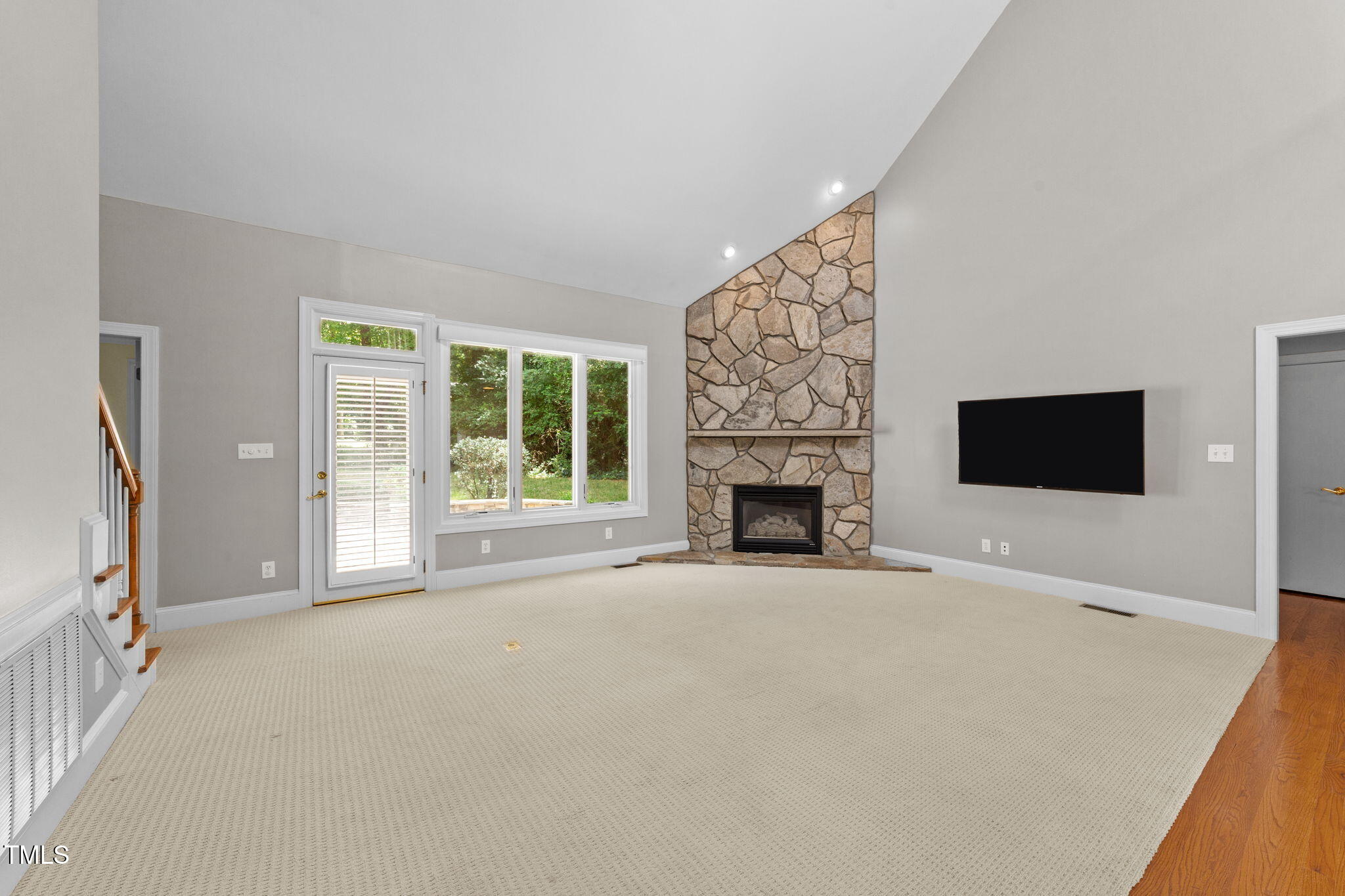 2613 Hawtree Drive Raleigh, NC 27613 - Photo 4 of 47 a view of an empty room with a fireplace and a window