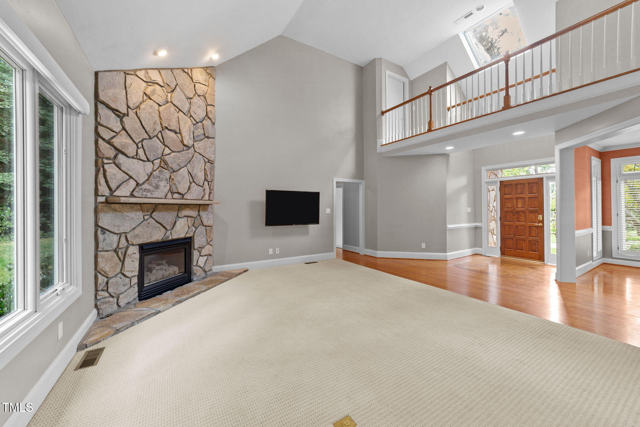 2613 Hawtree Drive Raleigh, NC 27613 - Photo 6 of 47 a view of a livingroom with an empty space and a fireplace