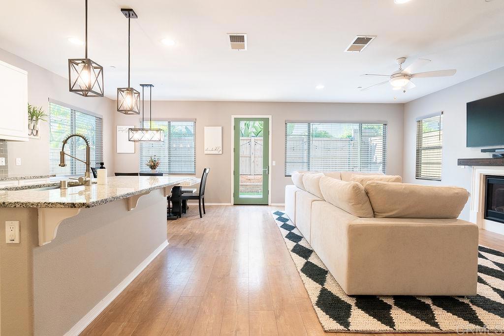 1132 Cherry Tree Lane Vista, CA 92084 - Photo 11 of 39 a living room with furniture a flat screen tv and a large window