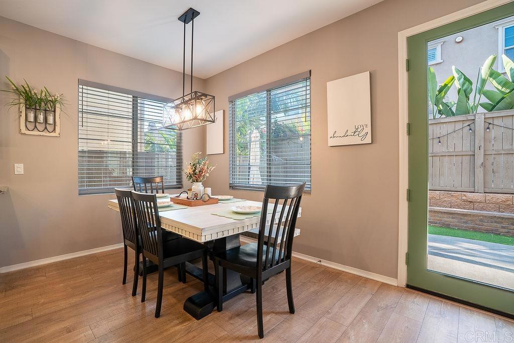 1132 Cherry Tree Lane Vista, CA 92084 - Photo 14 of 39 a dining room with furniture a chandelier and wooden floor