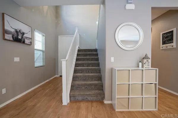 a view of a livingroom with wooden floor and white walls
