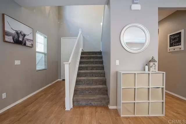 a view of a livingroom with wooden floor and white walls