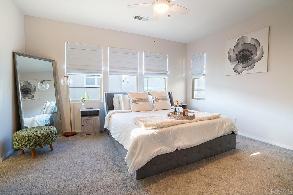 1132 Cherry Tree Lane Vista, CA 92084 - Photo 17 of 39 a bedroom with a bed and a large mirror