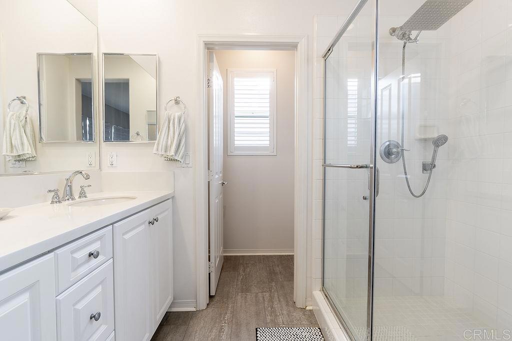 1132 Cherry Tree Lane Vista, CA 92084 - Photo 19 of 39 a bathroom with a double vanity sink a mirror and a shower