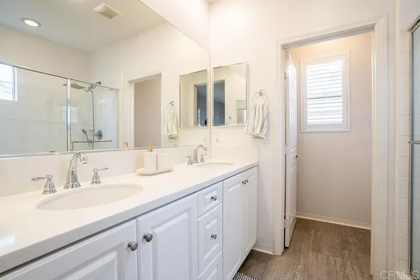 a bathroom with a sink double vanity and a mirror
