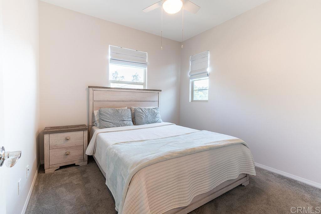 1132 Cherry Tree Lane Vista, CA 92084 - Photo 24 of 39 a bedroom with a bed and a window