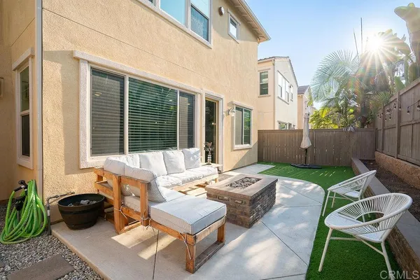 a view of a patio with couches table and chairs and potted plants