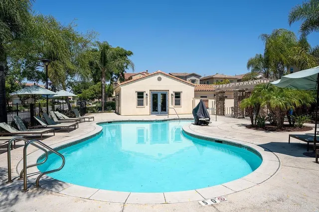 a view of a house with swimming pool and sitting area