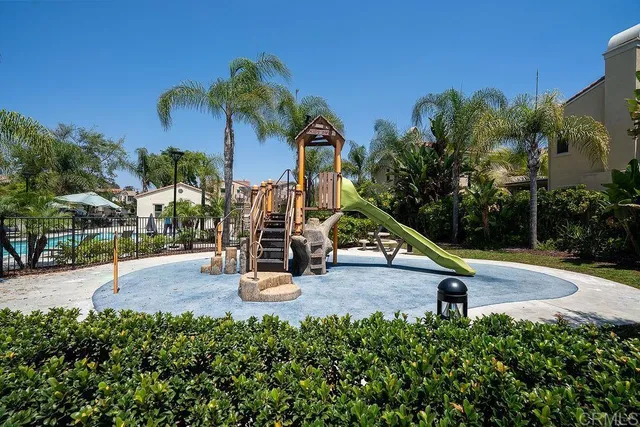 a view of a park with swings and slides