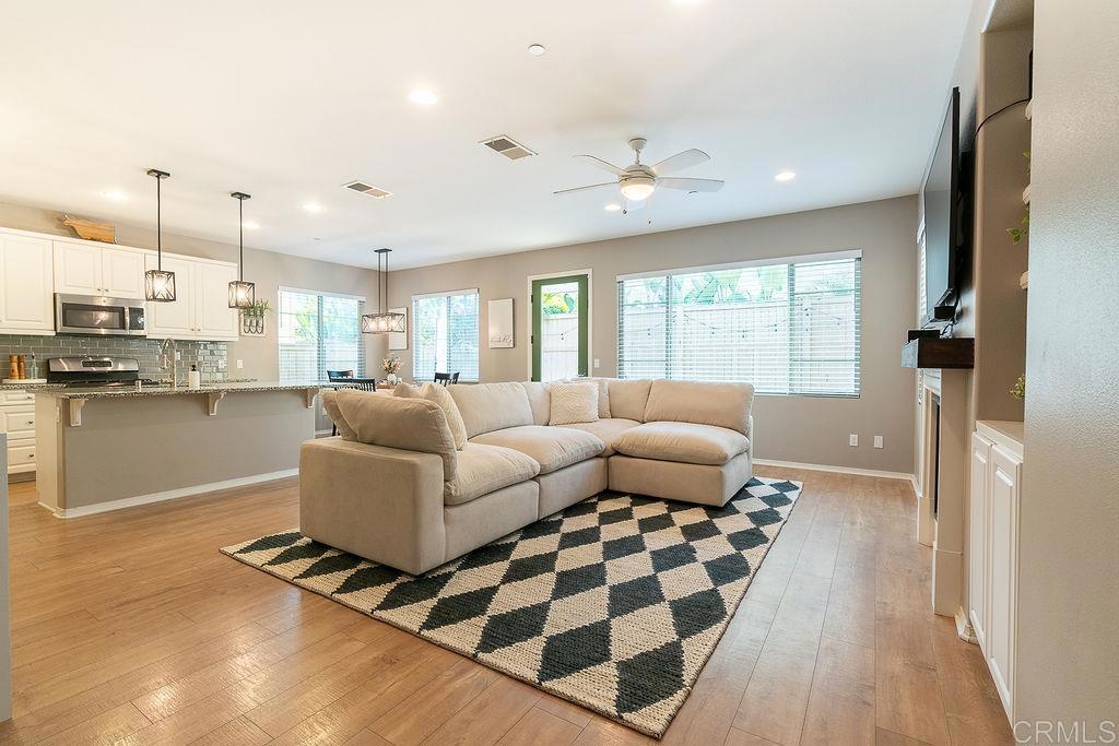 1132 Cherry Tree Lane Vista, CA 92084 - Photo 4 of 39 a living room with furniture and a flat screen tv