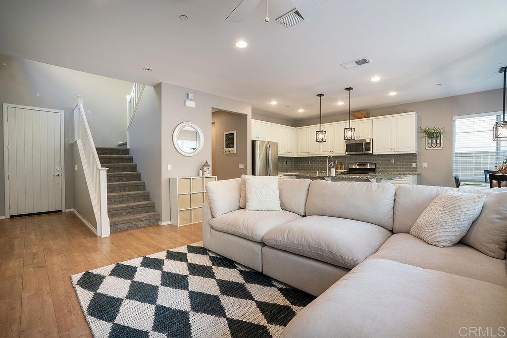 1132 Cherry Tree Lane Vista, CA 92084 - Photo 7 of 39 a living room with furniture and kitchen view with a fireplace
