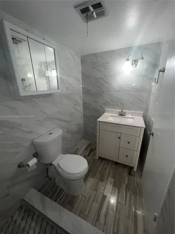 a bathroom with a sink toilet and mirror