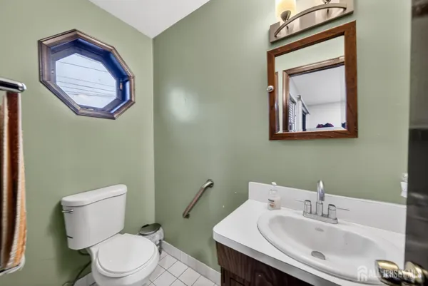 a bathroom with a toilet a sink and mirror