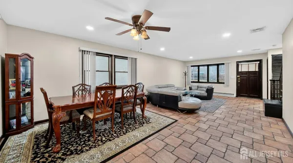 a living room with furniture a rug and a chandelier