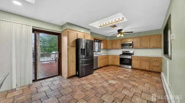 a kitchen with stainless steel appliances a refrigerator sink and cabinets