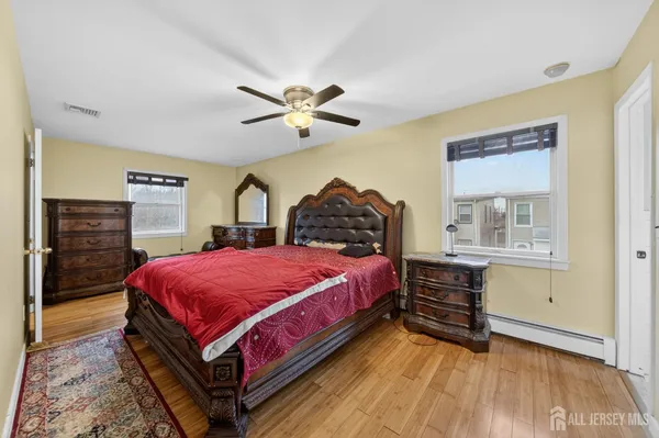 a bedroom with a bed dresser and a window