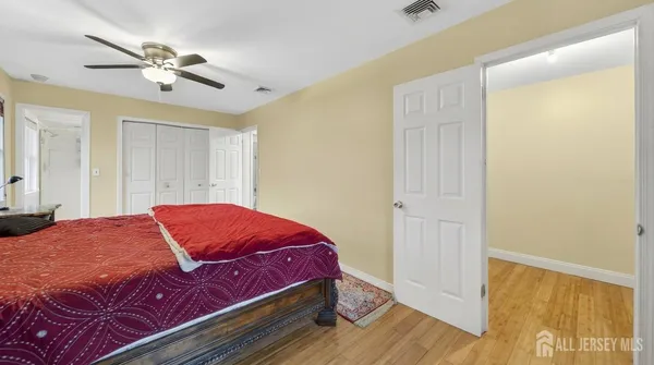 a bedroom with a bed and a ceiling fan