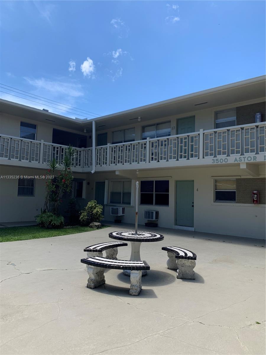 3500 Harrison Street, Unit 8 Hollywood, FL 33021 - Photo 12 of 59 a front view of a house with swimming pool outdoor seating and barbeque oven