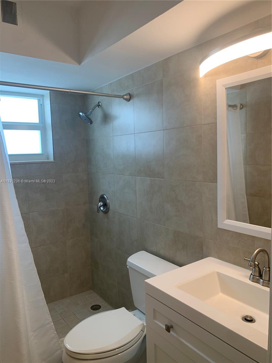 3500 Harrison Street, Unit 8 Hollywood, FL 33021 - Photo 16 of 59 a bathroom with a sink a toilet and shower