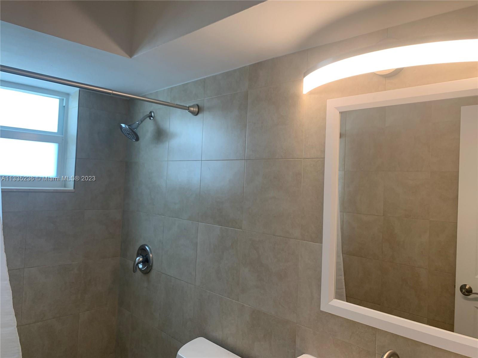 3500 Harrison Street, Unit 8 Hollywood, FL 33021 - Photo 17 of 59 a bathroom with a shower and a toilet