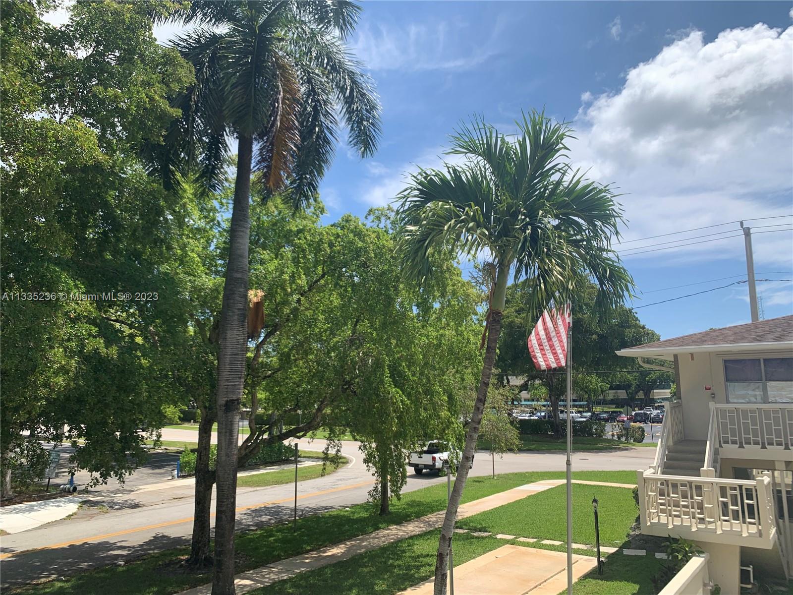 3500 Harrison Street, Unit 8 Hollywood, FL 33021 - Photo 2 of 59 a view of a swimming pool with a garden