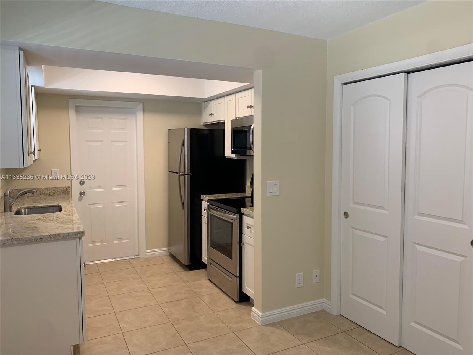 3500 Harrison Street, Unit 8 Hollywood, FL 33021 - Photo 40 of 59 a kitchen with a refrigerator and a sink