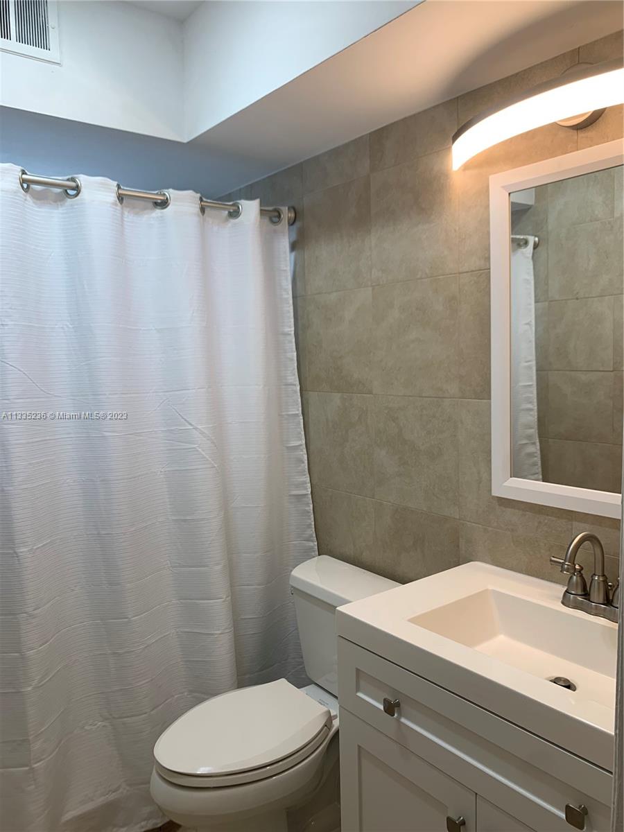 3500 Harrison Street, Unit 8 Hollywood, FL 33021 - Photo 56 of 59 a bathroom with a sink and a mirror