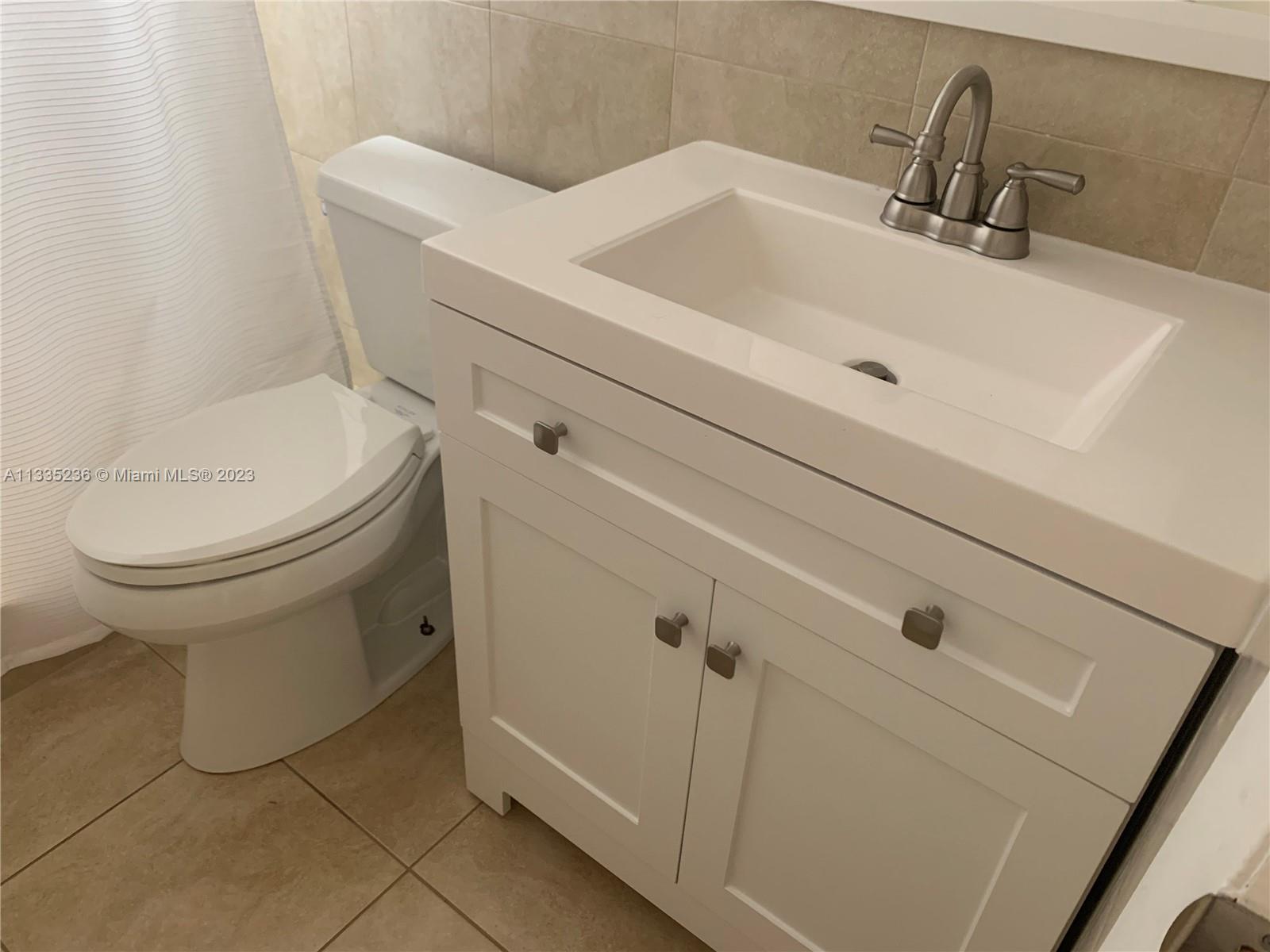 3500 Harrison Street, Unit 8 Hollywood, FL 33021 - Photo 7 of 59 a bathroom with a sink and a toilet
