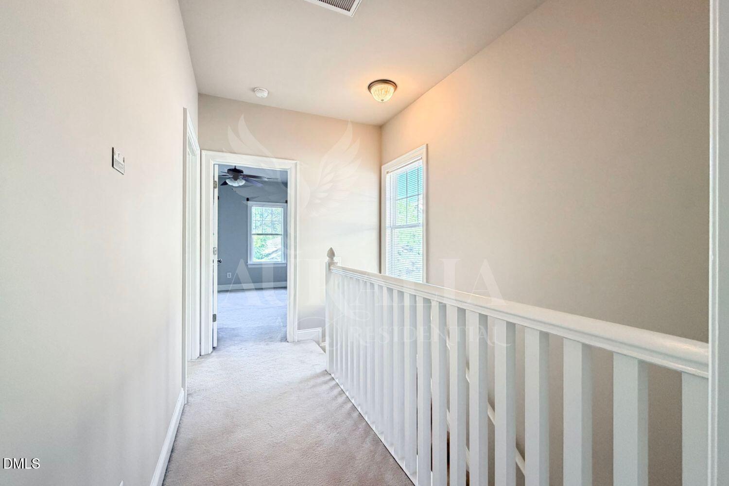 7754 ACC Boulevard Raleigh, NC 27617 - Photo 22 of 41 a view of a hallway with a livingroom and a bathroom