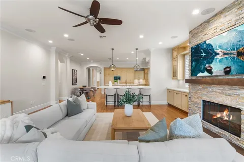 a living room with furniture fireplace and a large window