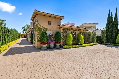 a view of a street with potted plants