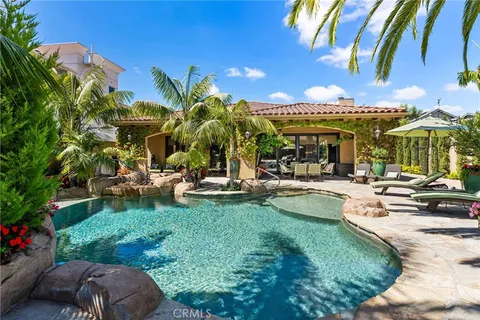 a view of a backyard with plants and swimming pool