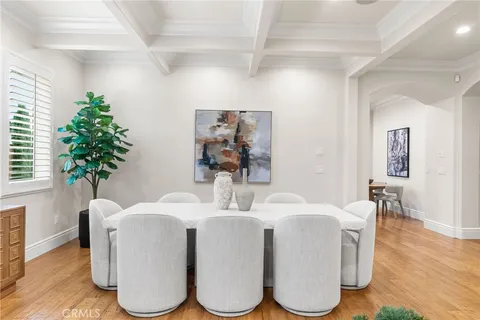 a dining room with furniture and a potted plant