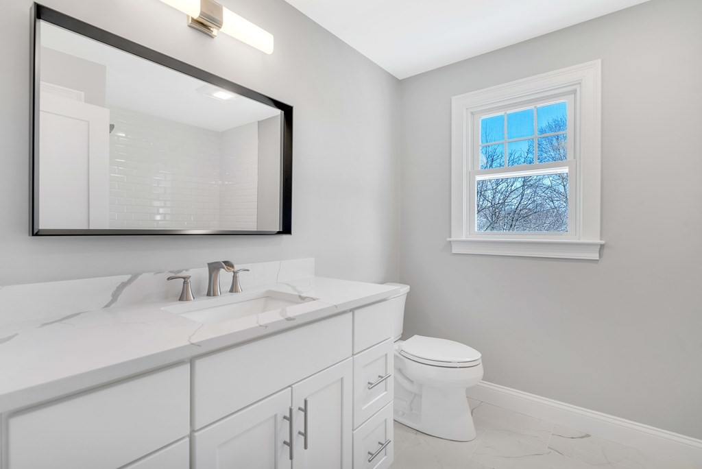 74 Robert Road Stow, MA 01775 - Photo 30 of 36 a bathroom with a toilet a sink and mirror