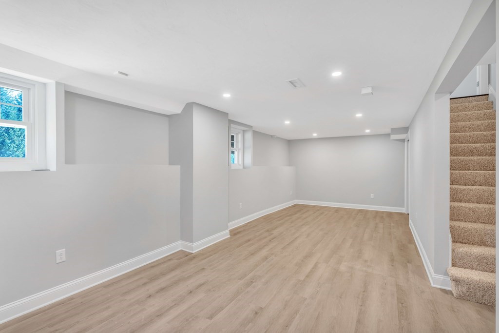 74 Robert Road Stow, MA 01775 - Photo 33 of 36 a view of an empty room with wooden floor and a window