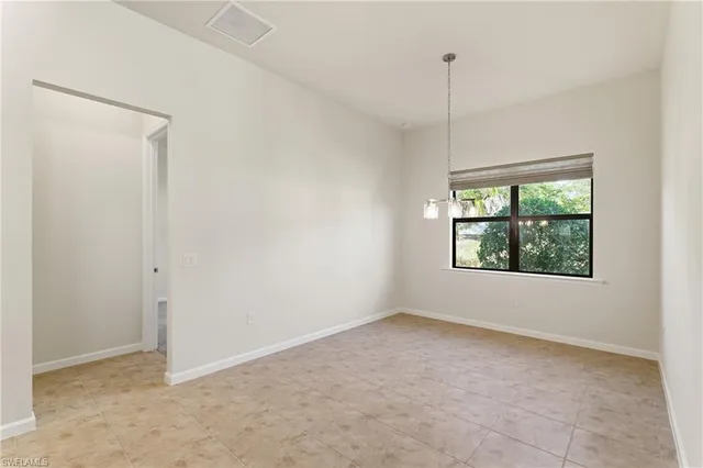 an empty room with windows and entrance