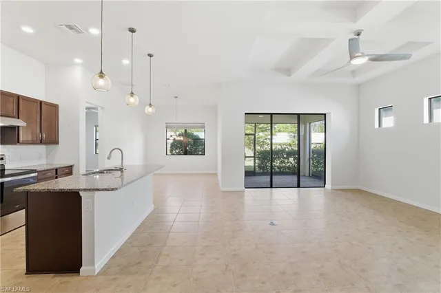 a large white kitchen with a large window