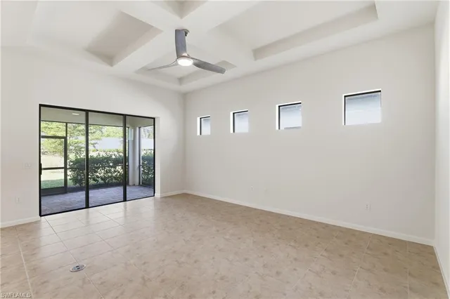 an empty room with windows and city view