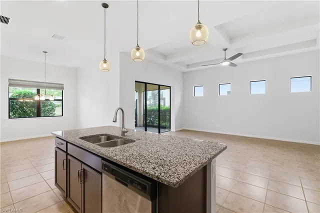 a kitchen with kitchen island a counter space a sink appliances and a counter top space